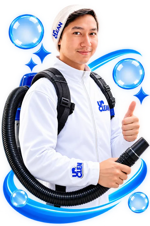 UpClean office cleaning team member in a white UpClean jacket with a backpack vacuum, giving a thumbs up in Kelowna